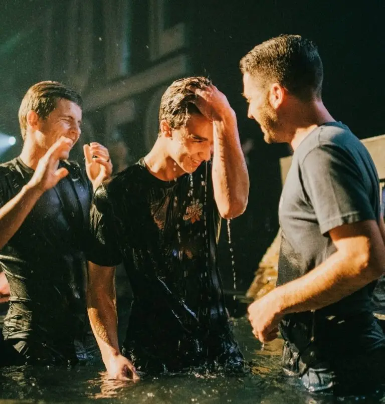 baptism representation with young men in water joyous upon baptism