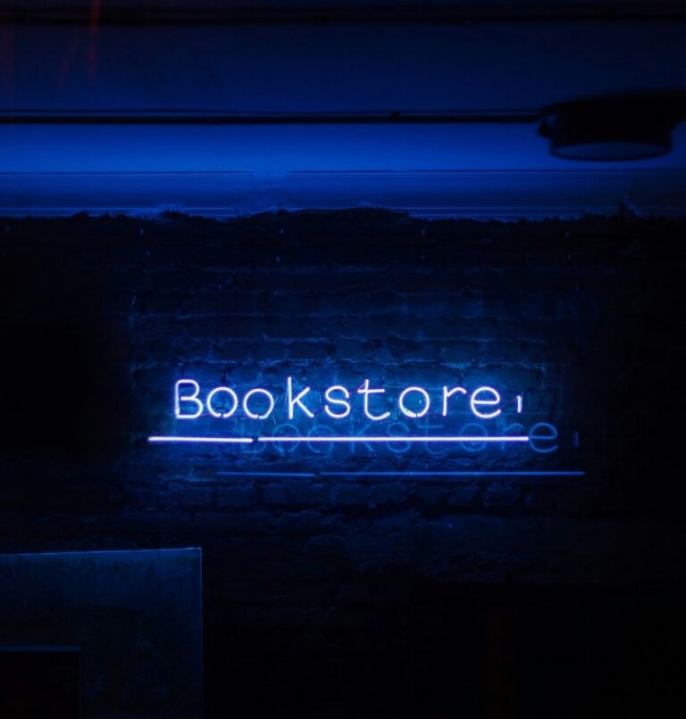 neon blue "bookstore" sign on a black wall for find a christian bookstore near me article