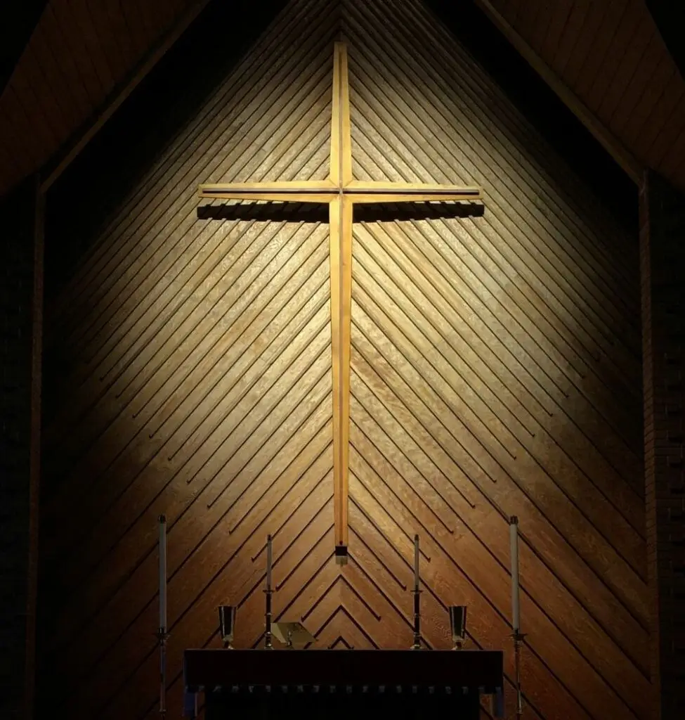 lent showcased with a gold cross with spotlight