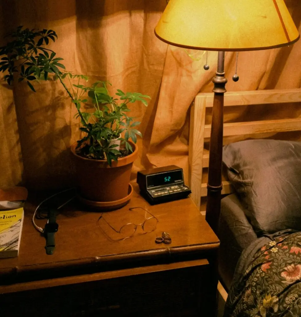 Nightstand, bed and lamp before bedtime prayers