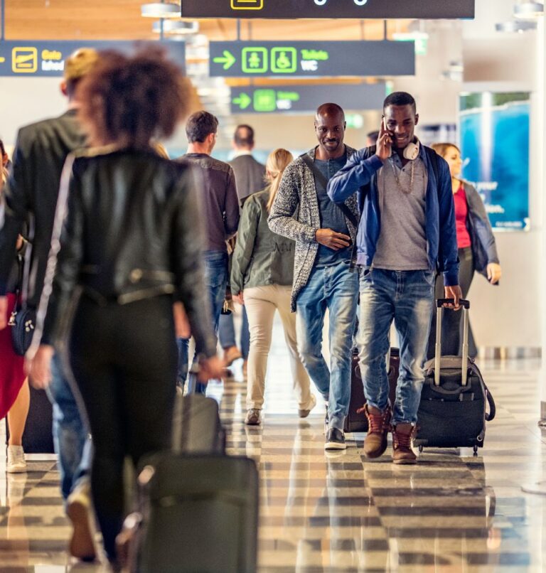 Travelers walking through busy airport